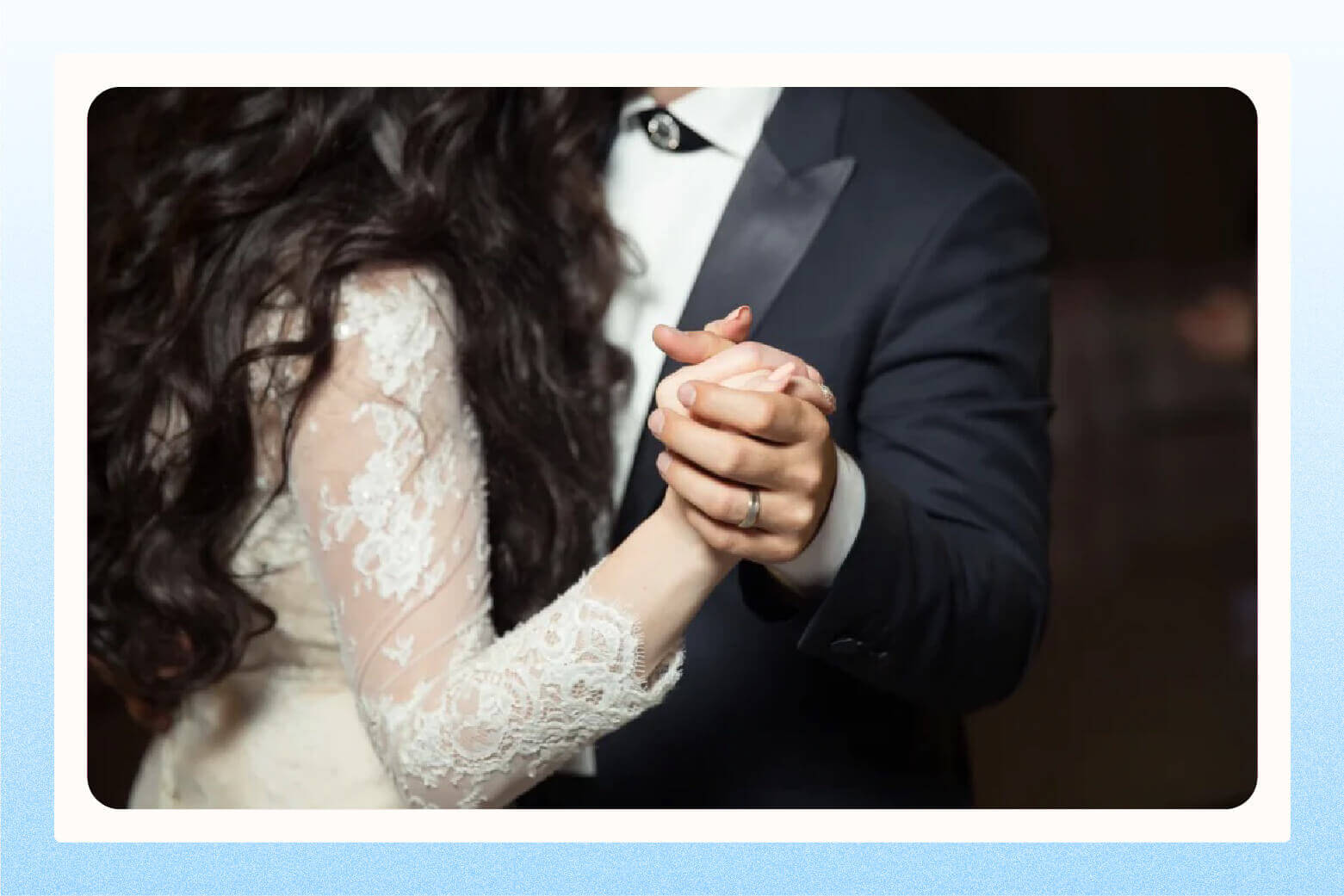 Close up image of wedding couple's hands while they dance closely 