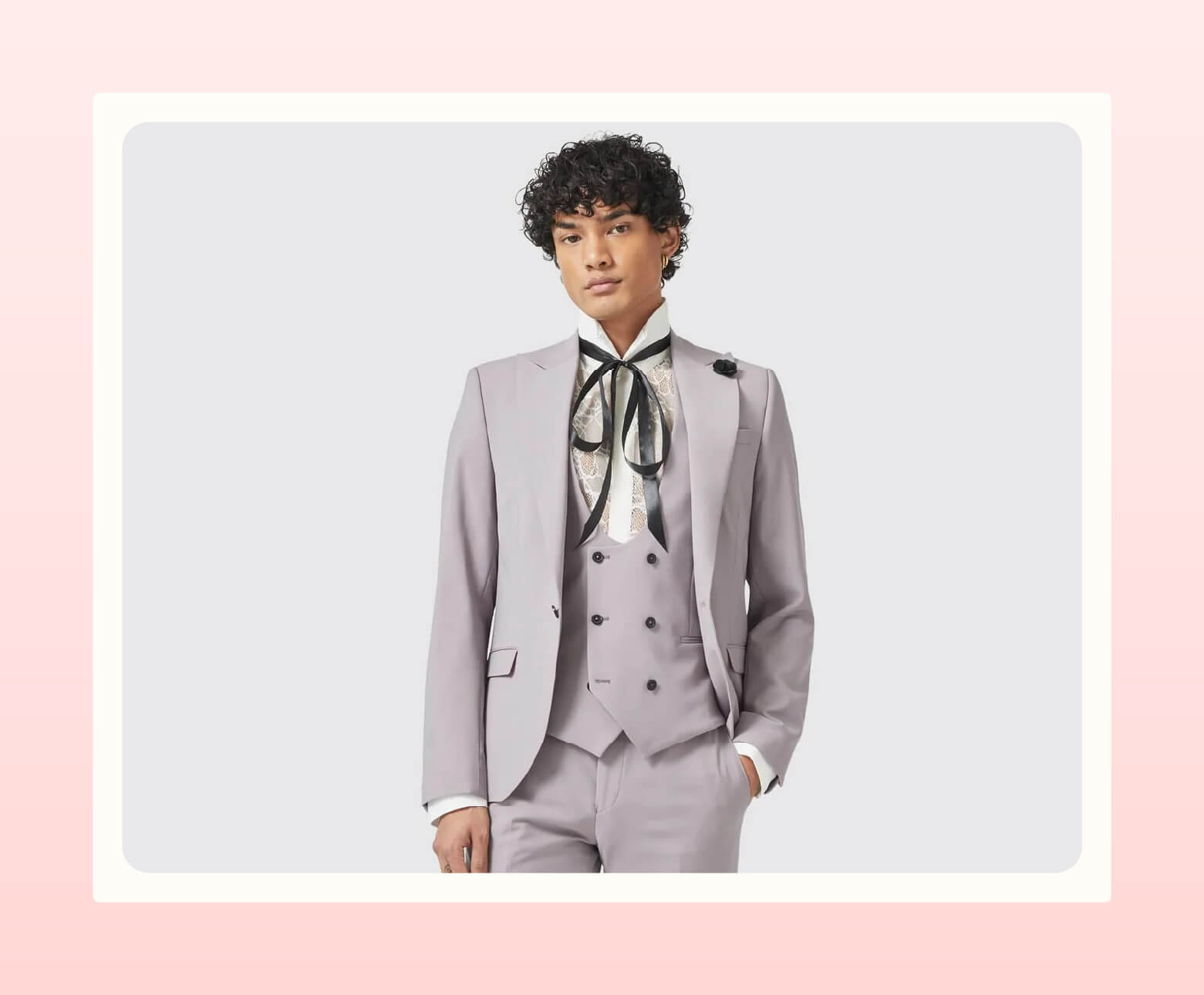 A person wearing a pale violet suit from Twisted Tailor with a vest, lace shirt, and ribbon bow around collar