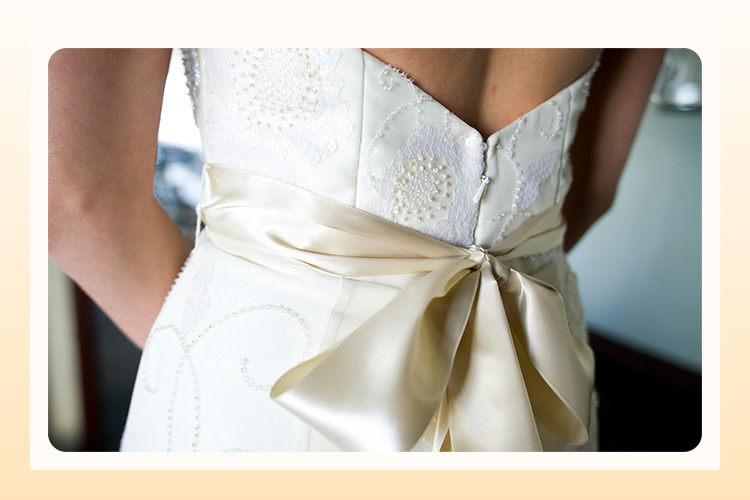 the back of a wedding dress with a bow