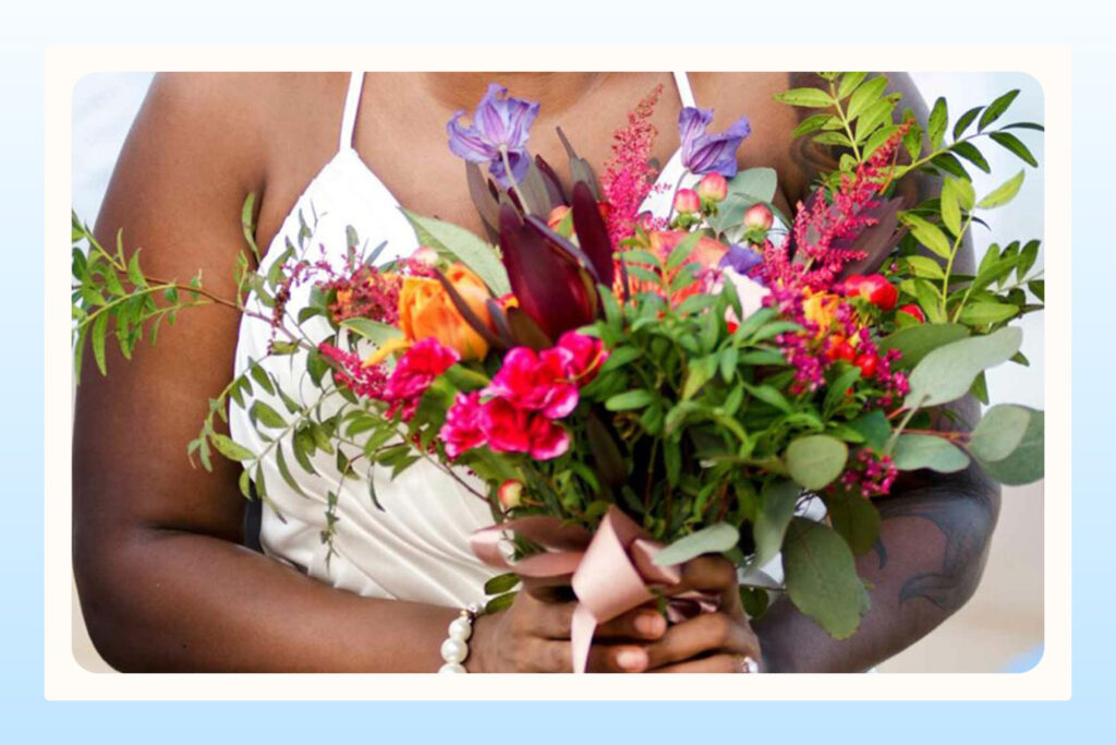 bride holding bright tropical colored bouquet