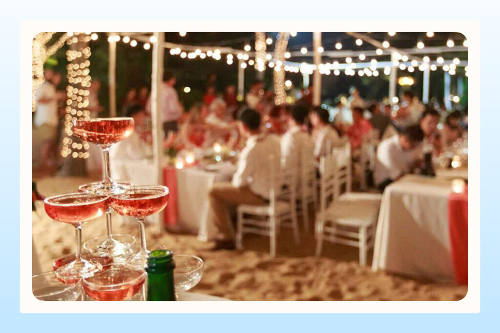 view of people dining at an evening wedding reception with string light decor