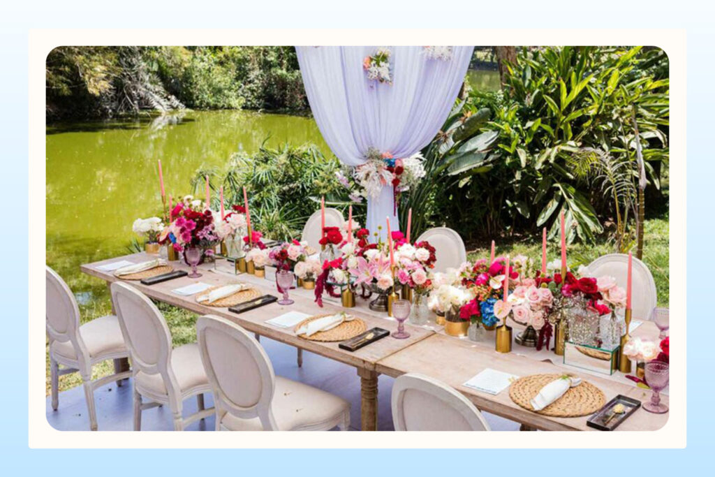 outdoor wedding venue with floral centerpieces next to a lake