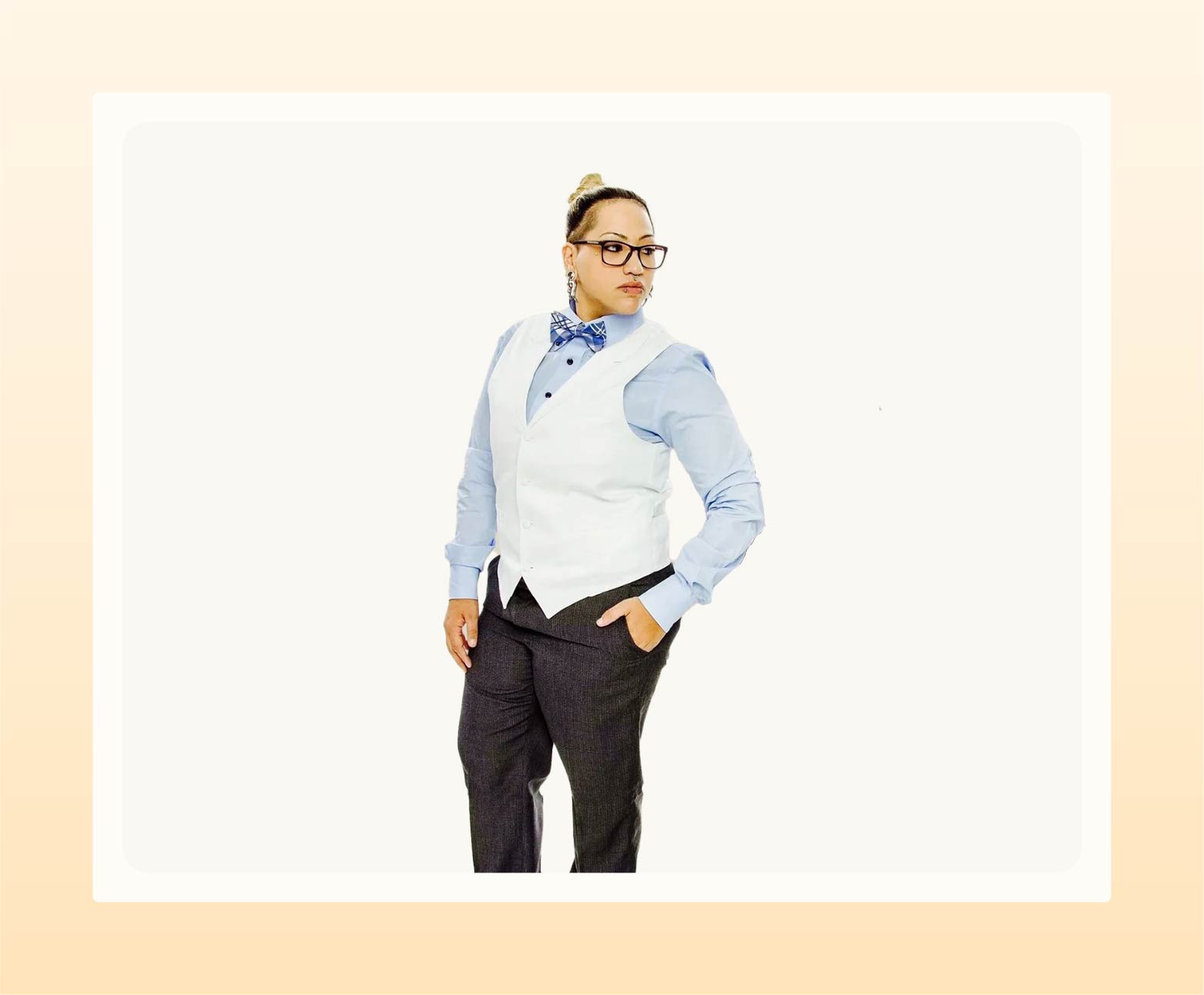 Model wearing white vest over blue button-up with bow tie as semi-formal wedding attire