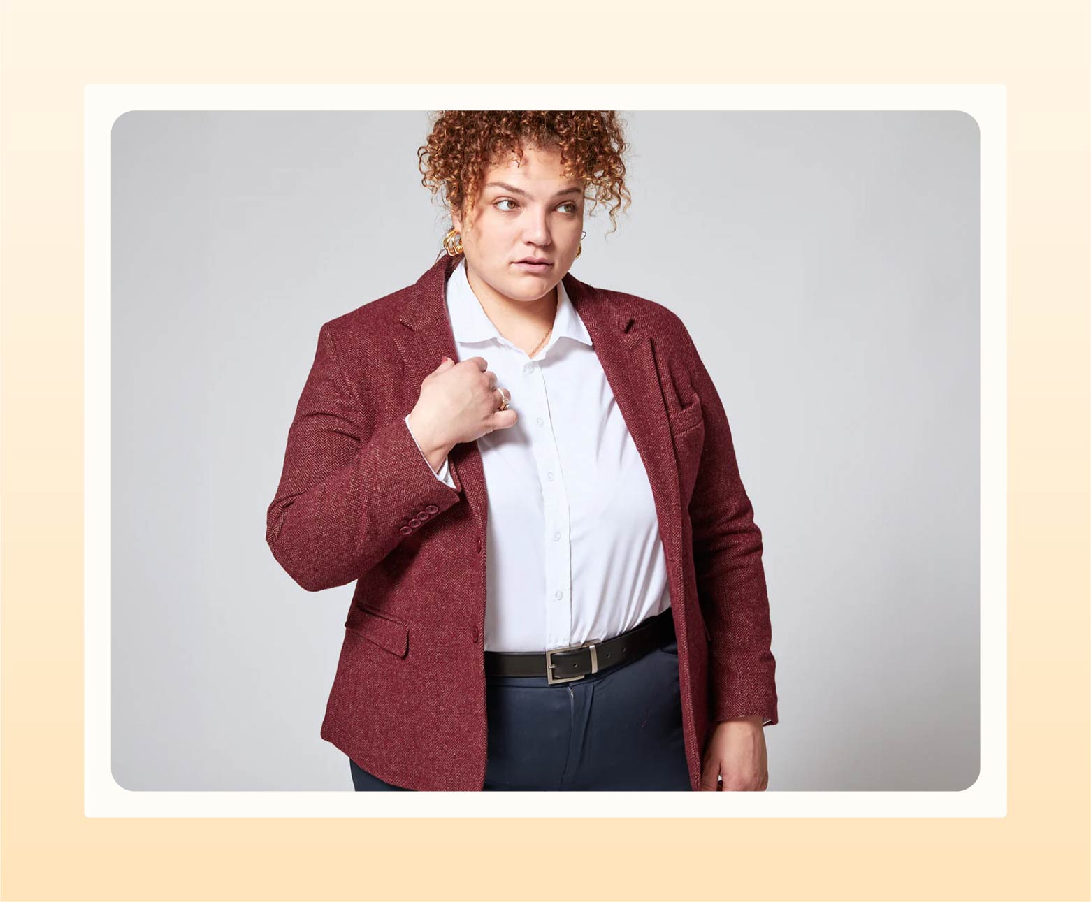 Model wearing tweed herringbone blazer with white button-up and slacks as semi-formal wedding attire