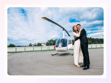 Bride and groom about to ride in a helicopter.