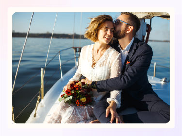 Bride and groom embracing on a sailboat.