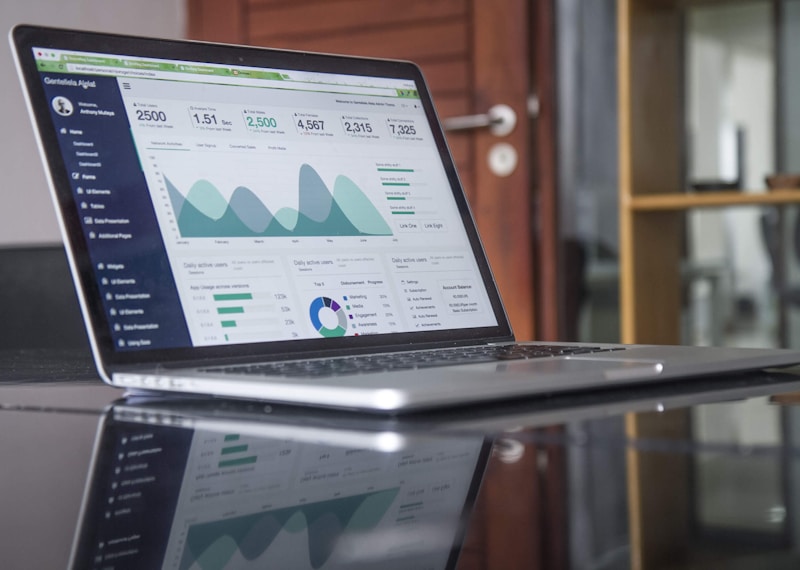 Financial planning workspace with charts and laptop