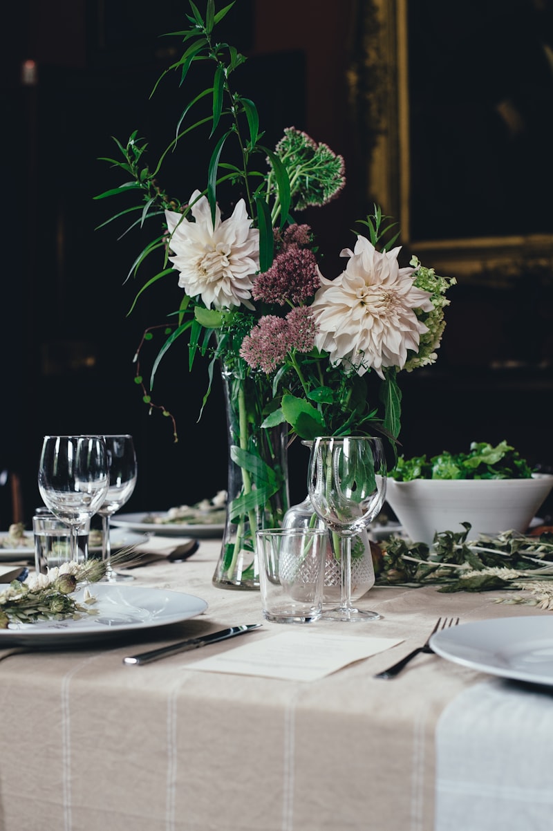 Wedding reception tables set with white linens, candles, and floral centerpieces