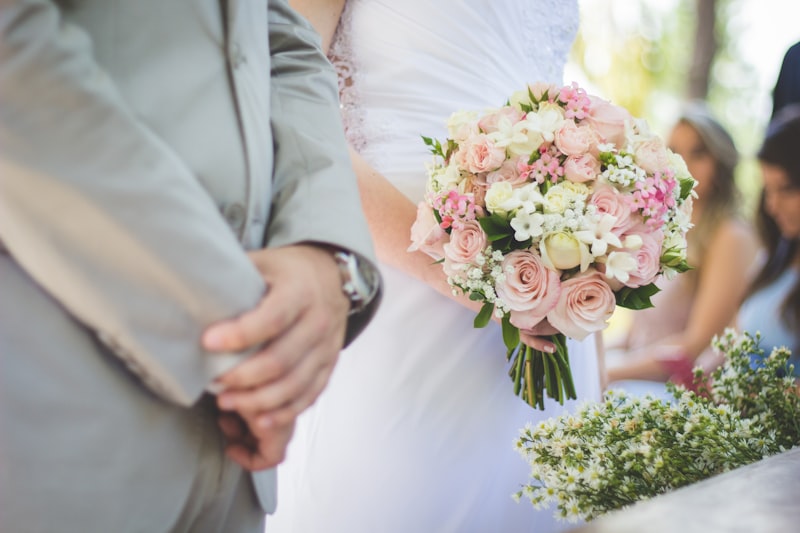 Bridal bouquet with white and blush flowers held by bride