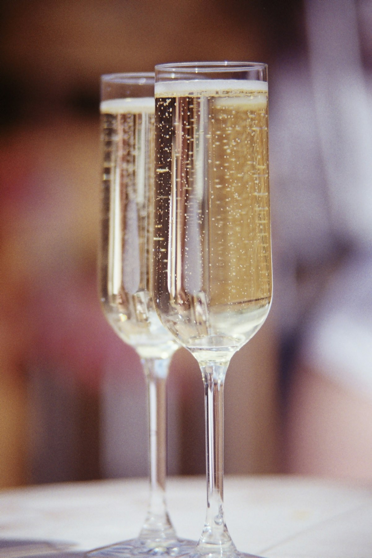 Two champagne flutes ready for a wedding toast