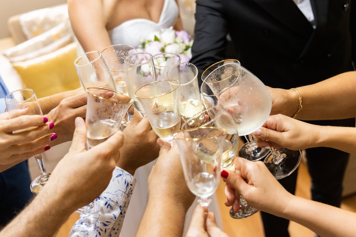 Wedding guests standing to raise a toast during reception speeches