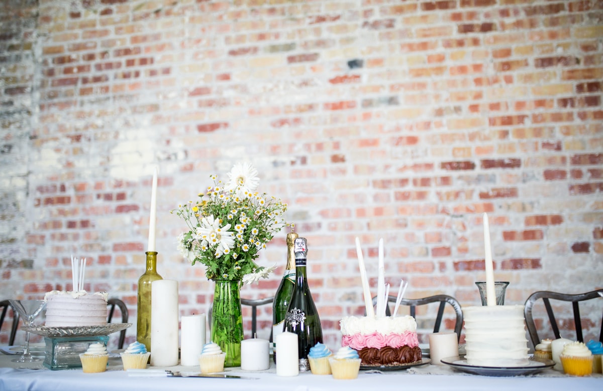 Wedding planning notebook and pen on a table with floral arrangements in the background