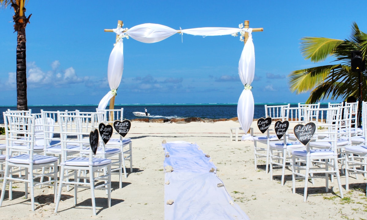 Beach wedding venue decorated for a tropical ceremony with ocean backdrop