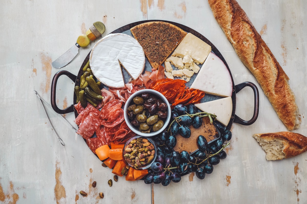 Charcuterie and appetizer grazing table with cheeses, fruits, and crackers for an engagement party
