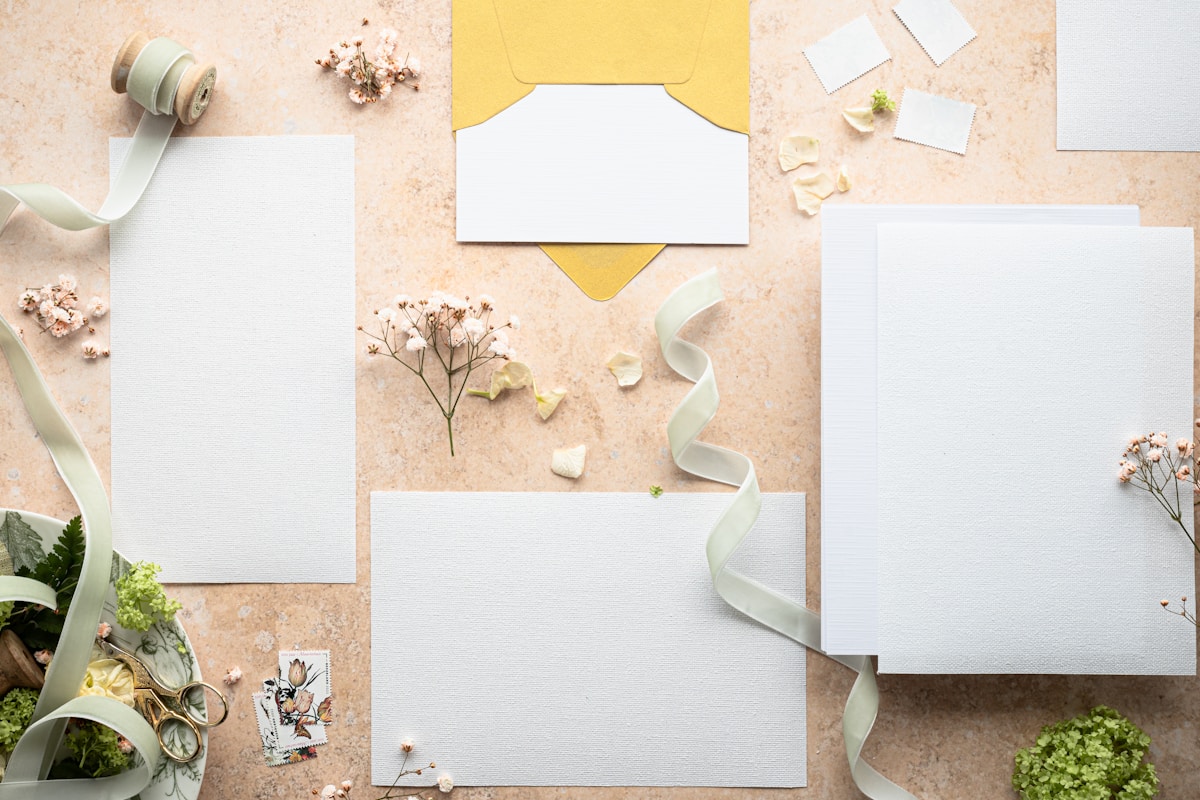 Matching wedding invitation suite with envelopes, ribbon, and enclosure cards laid flat