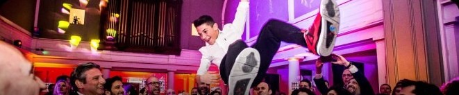 A boy lifted on a chair at his bar mitzvah