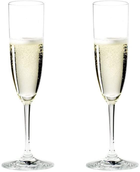 Two clear Champagne flutes filled halfway with Champagne