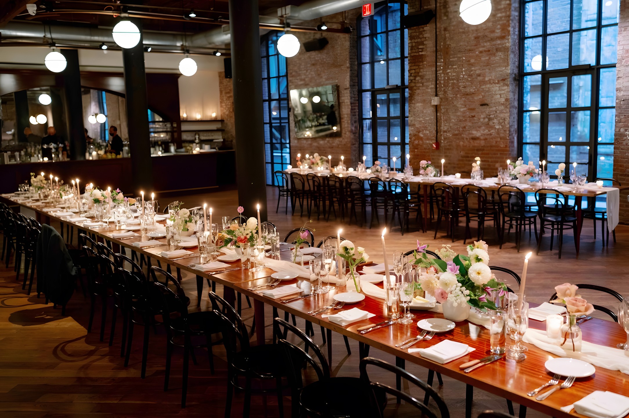 Reception dinner table at Wythe Hotel with candles, long tables, florals.
